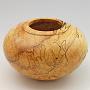 This is hollow form is spalted Maple, about 5 3/4" wide by 3 1/2" tall.